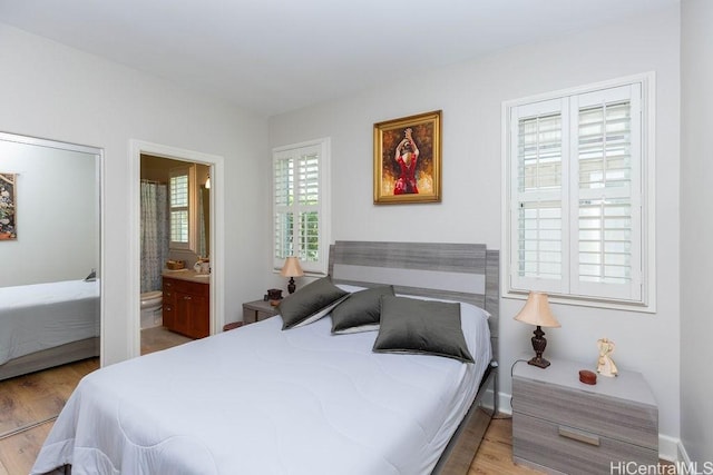 91-1068 Kaikohola St, Ewa Beach, HI 96706 - bedroom with connected bathroom and wood finished floors