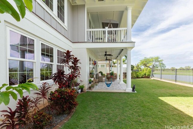 91-1068 Kaikohola St, Ewa Beach, HI 96706 - exterior space with a patio area, a balcony, a ceiling fan, a fenced backyard, and a yard