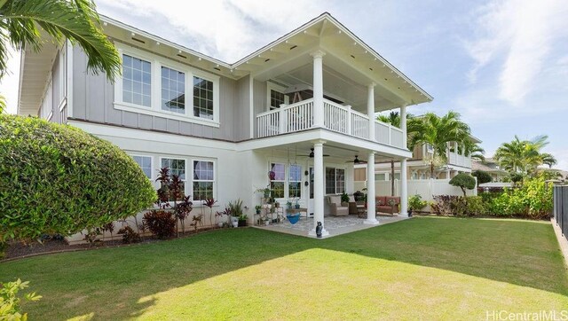 91-1068 Kaikohola St, Ewa Beach, HI 96706 - rear view of house featuring fence, ceiling fan, a balcony, board and batten siding, and an outdoor living space