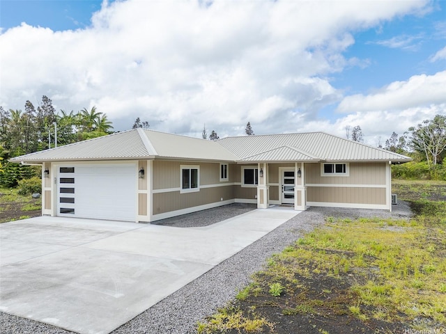 15-1692 7th Ave, Keaau, HI 96749 - view of front facade featuring a garage, metal roof, and concrete driveway