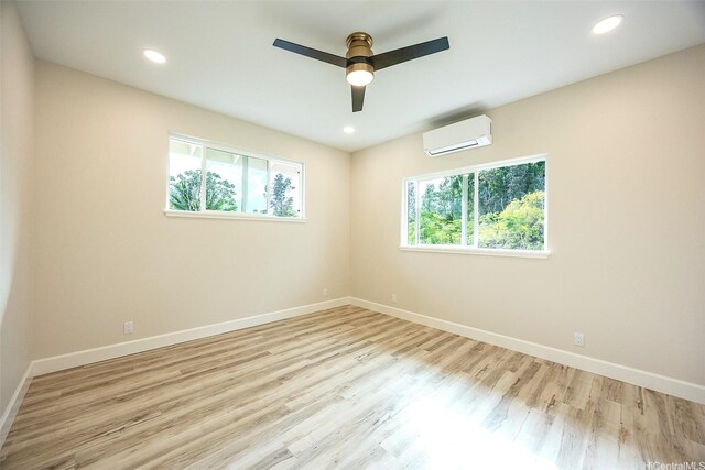 15-1692 7th Ave, Keaau, HI 96749 - spare room with a wall mounted air conditioner, baseboards, wood finished floors, and recessed lighting