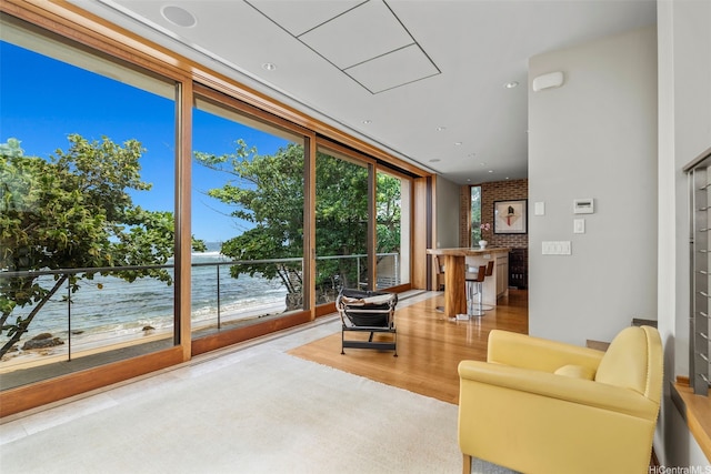 61-279 Kamehameha Hwy, Haleiwa, HI 96712 - living area featuring wood finished floors, a water view, and a wall of windows