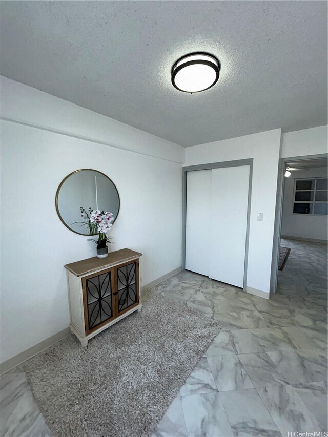 837 Kapahulu Ave Unit 302, Honolulu, HI 96816 - foyer entrance with marble look tiles and a textured ceiling