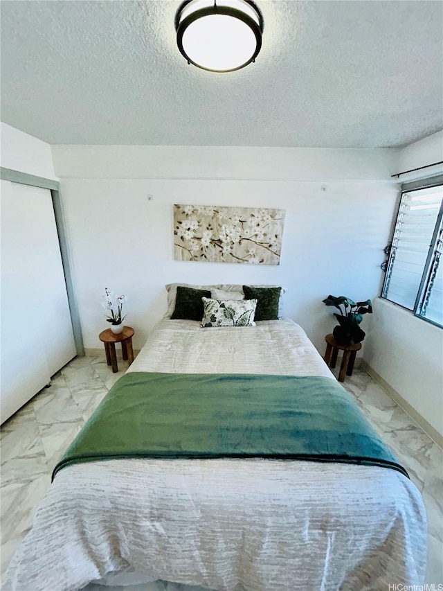 837 Kapahulu Ave Unit 302, Honolulu, HI 96816 - bedroom featuring marble finish flooring and a textured ceiling