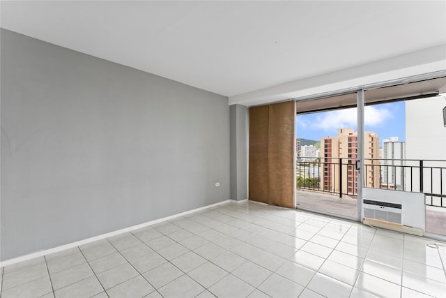 1415 Victoria St Unit 1002, Honolulu, HI 96822 - tiled spare room with a wall of windows, a view of city, baseboards, and a wall unit AC