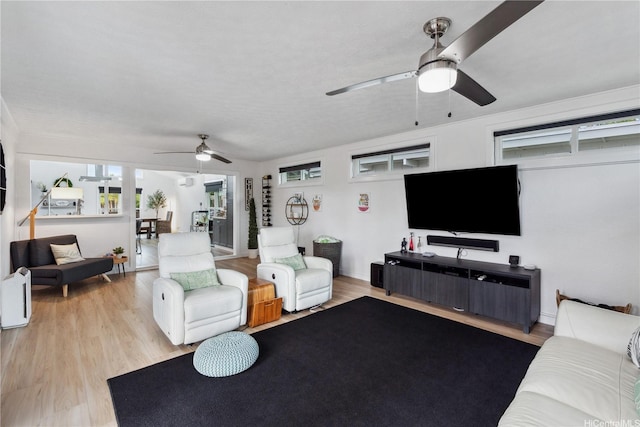 living room with a ceiling fan and wood finished floors