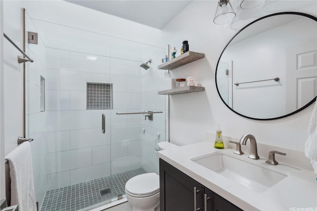 full bathroom with vanity, toilet, and a stall shower