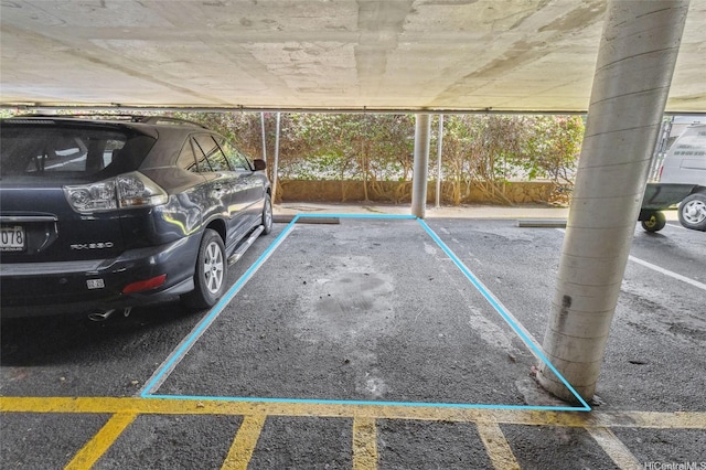 view of vehicle parking with a parking garage