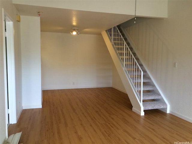 432 Mananai Pl Unit 18C, Honolulu, HI 96818 - unfurnished living room with baseboards, stairs, and wood finished floors