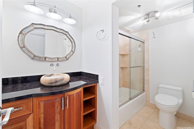 322 Aoloa St Unit 907, Kailua, HI 96734 - bathroom featuring tile patterned floors, combined bath / shower with glass door, toilet, vanity, and baseboards