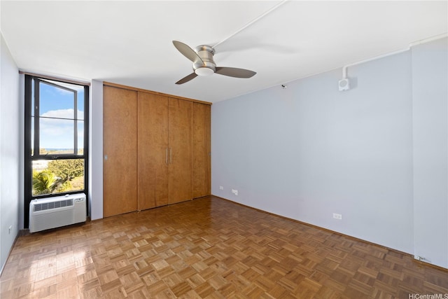 322 Aoloa St Unit 907, Kailua, HI 96734 - unfurnished bedroom featuring an AC wall unit, expansive windows, a ceiling fan, and a closet