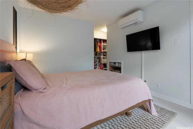 6129 Summer St Unit 6129D, Honolulu, HI 96821 - bedroom with a wall mounted AC, a walk in closet, a closet, and baseboards