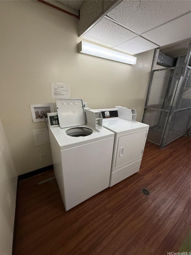 229 Paoakalani Ave Unit 1803, Honolulu, HI 96815 - community laundry room with washing machine and dryer and dark wood-style flooring