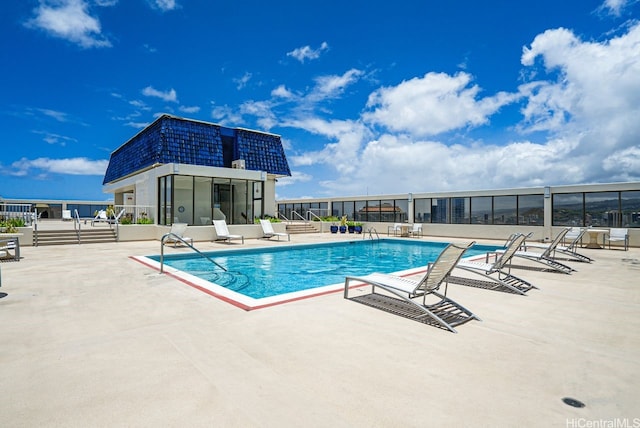 community pool featuring fence and a patio area