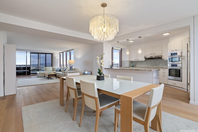 425 S St Unit 2004, Honolulu, HI 96813 - dining area with a chandelier and light wood finished floors