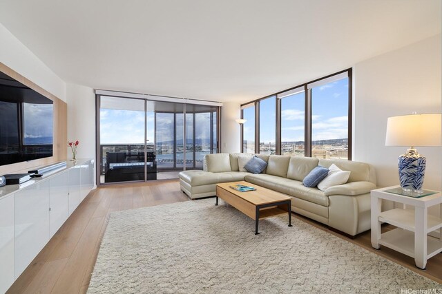 425 S St Unit 2004, Honolulu, HI 96813 - living room with a wall of windows and light wood-type flooring