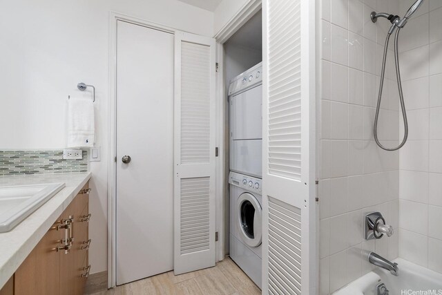 425 S St Unit 2004, Honolulu, HI 96813 - laundry room with estacked washer and dryer and light wood-type flooring