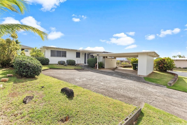 ranch-style house with aphalt driveway, a front lawn, and an attached carport