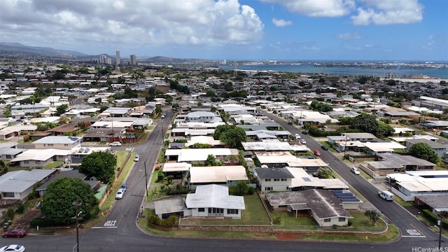 drone / aerial view featuring a residential view and a water and mountain view