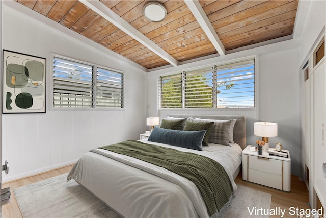 bedroom with wood finished floors, lofted ceiling with beams, and wood ceiling