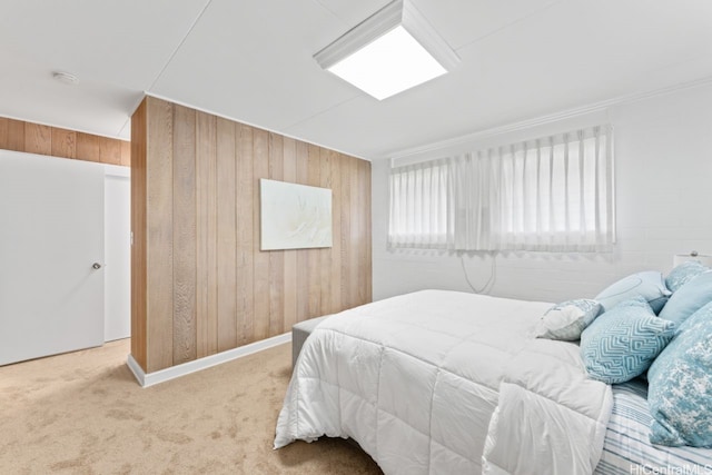 carpeted bedroom featuring wooden walls