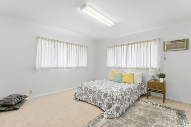 carpeted bedroom with a wall mounted AC and baseboards