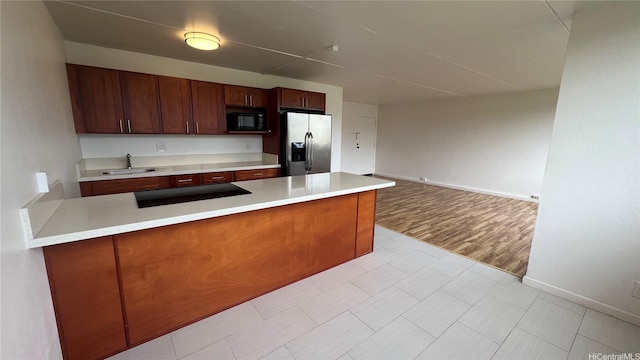 95-29 Kuahelani Ave Unit 226, Mililani, HI 96789 - kitchen featuring stainless steel fridge, black microwave, light countertops, and stovetop