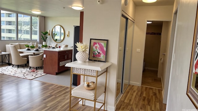 interior space with baseboards and wood finished floors