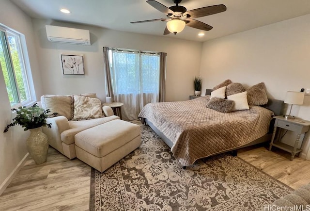 bedroom featuring recessed lighting, a wall mounted AC, wood finished floors, and baseboards