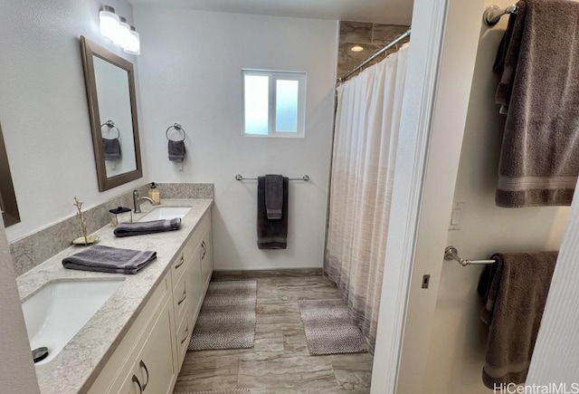 full bathroom with a shower with curtain, a sink, and double vanity