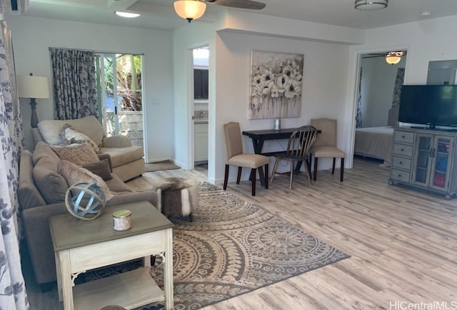 living room with wood finished floors and ceiling fan