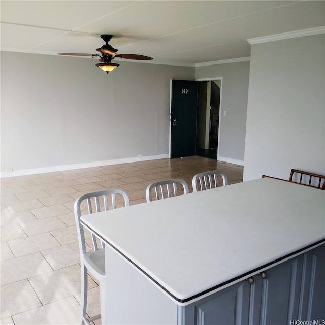 dining room featuring crown molding, light tile patterned floors, ceiling fan, and baseboards