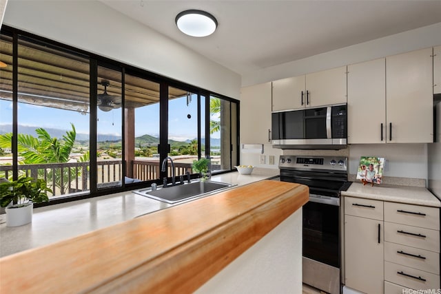 46-058 Aliikane Pl Unit 2123, Kaneohe, HI 96744 - kitchen with appliances with stainless steel finishes and a sink