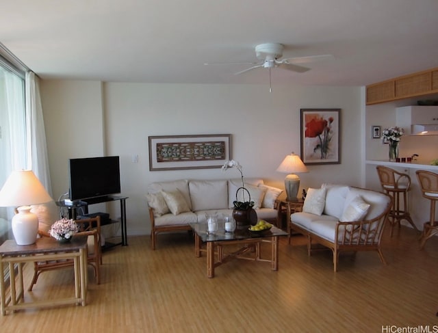 living room with light wood finished floors and a ceiling fan