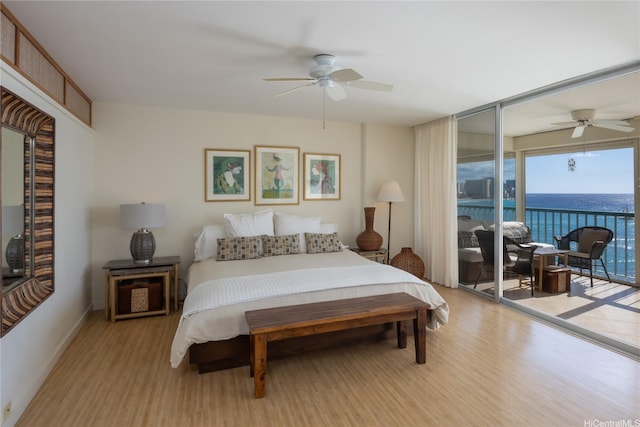 2877 Kalakaua Ave Unit 1105, Honolulu, HI 96815 - bedroom with a ceiling fan, baseboards, a water view, access to outside, and wood finished floors