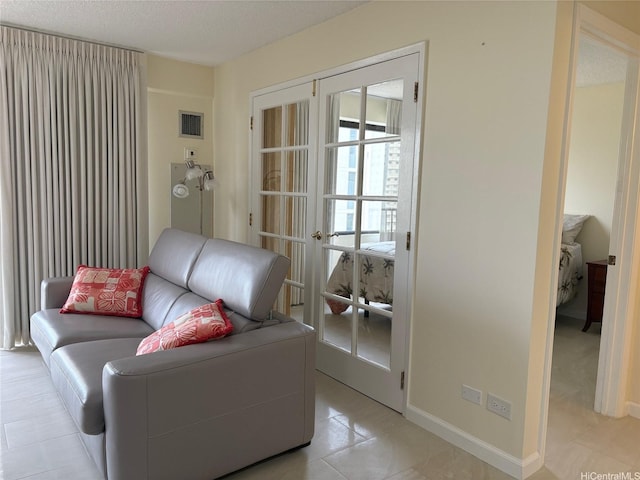 2140 Kuhio Ave Unit 911, Honolulu, HI 96815 - living area featuring light tile patterned floors, visible vents, baseboards, and a textured ceiling