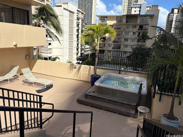 2140 Kuhio Ave Unit 911, Honolulu, HI 96815 - view of patio / terrace with a hot tub and a view of city
