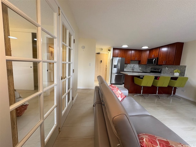 2140 Kuhio Ave Unit 911, Honolulu, HI 96815 - interior space featuring french doors, recessed lighting, a textured ceiling, baseboards, and light tile patterned flooring