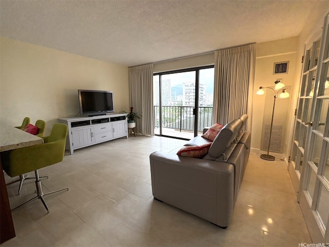 2140 Kuhio Ave Unit 911, Honolulu, HI 96815 - living room with light tile patterned floors, visible vents, and a textured ceiling