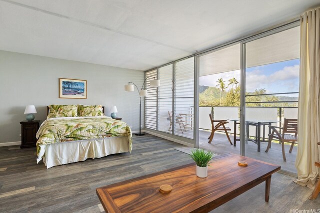 53-549 Kamehameha Hwy Unit 505, Hauula, HI 96717 - bedroom featuring access to exterior, multiple windows, wood finished floors, and baseboards