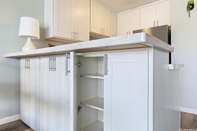 53-549 Kamehameha Hwy Unit 505, Hauula, HI 96717 - interior space featuring baseboards, wood finished floors, white cabinetry, and light countertops