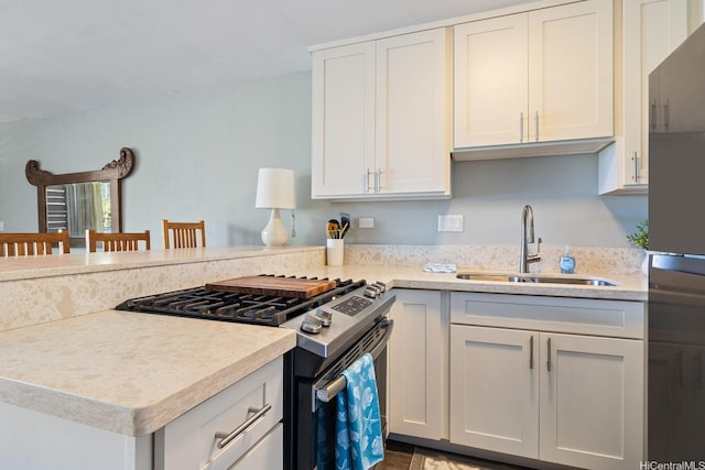 53-549 Kamehameha Hwy Unit 505, Hauula, HI 96717 - kitchen with light countertops, white cabinets, a sink, stainless steel range with gas cooktop, and a peninsula