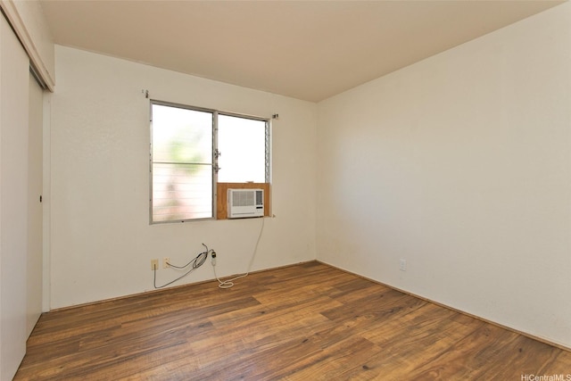 unfurnished room featuring wood finished floors and cooling unit