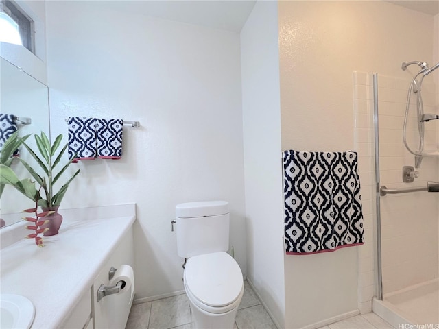 full bathroom with tile patterned floors, a tile shower, toilet, and vanity