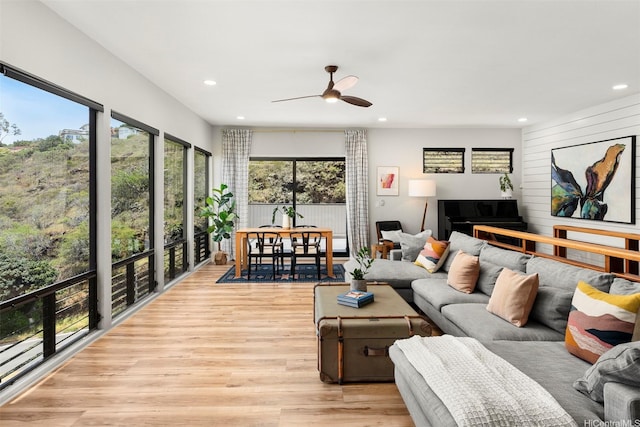 living room featuring recessed lighting, a ceiling fan, and light wood-type flooring