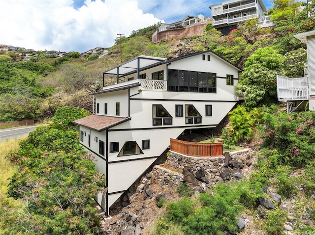 back of property with a balcony