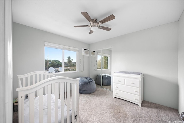91-444 Pohakupuna Rd, Ewa Beach, HI 96706 - bedroom featuring a wall unit AC, a ceiling fan, carpet floors, a crib, and a closet