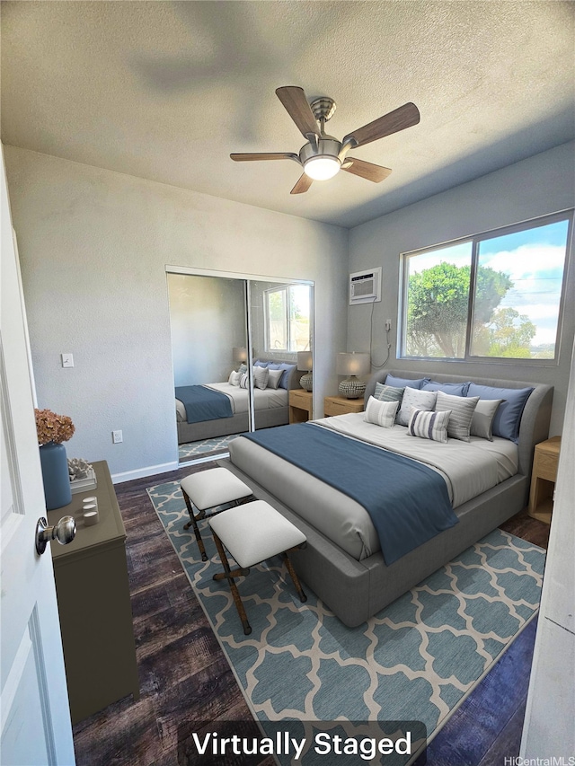 91-444 Pohakupuna Rd, Ewa Beach, HI 96706 - bedroom with a closet, dark wood-style floors, an AC wall unit, a textured ceiling, and a ceiling fan