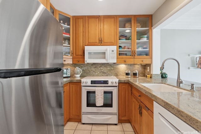 6370 Hawaii Kai Dr Unit 37, Honolulu, HI 96825 - kitchen with white appliances, brown cabinetry, light tile patterned floors, tasteful backsplash, and glass insert cabinets