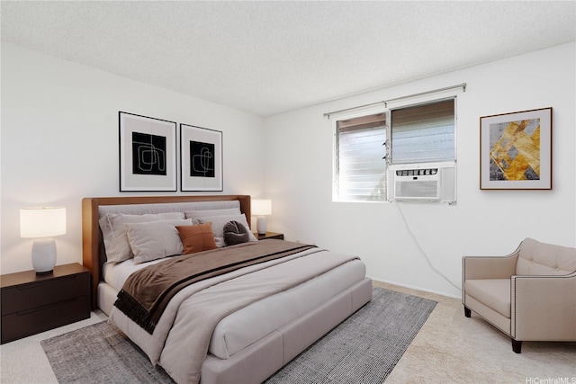 bedroom featuring a textured ceiling, cooling unit, and carpet floors